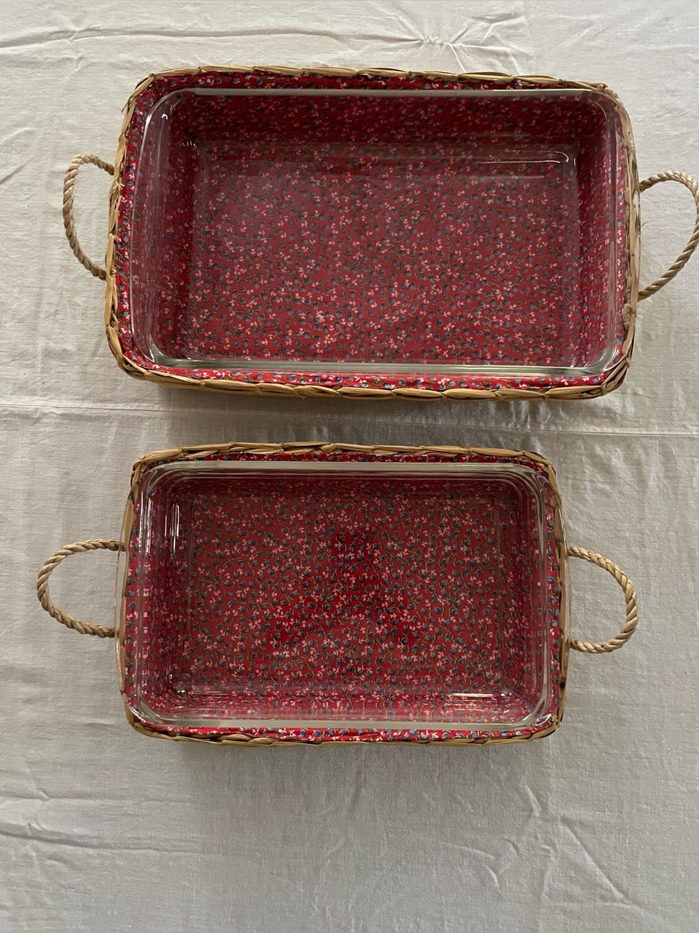Two rectangular Pyrex baking dishes with woven carriers.